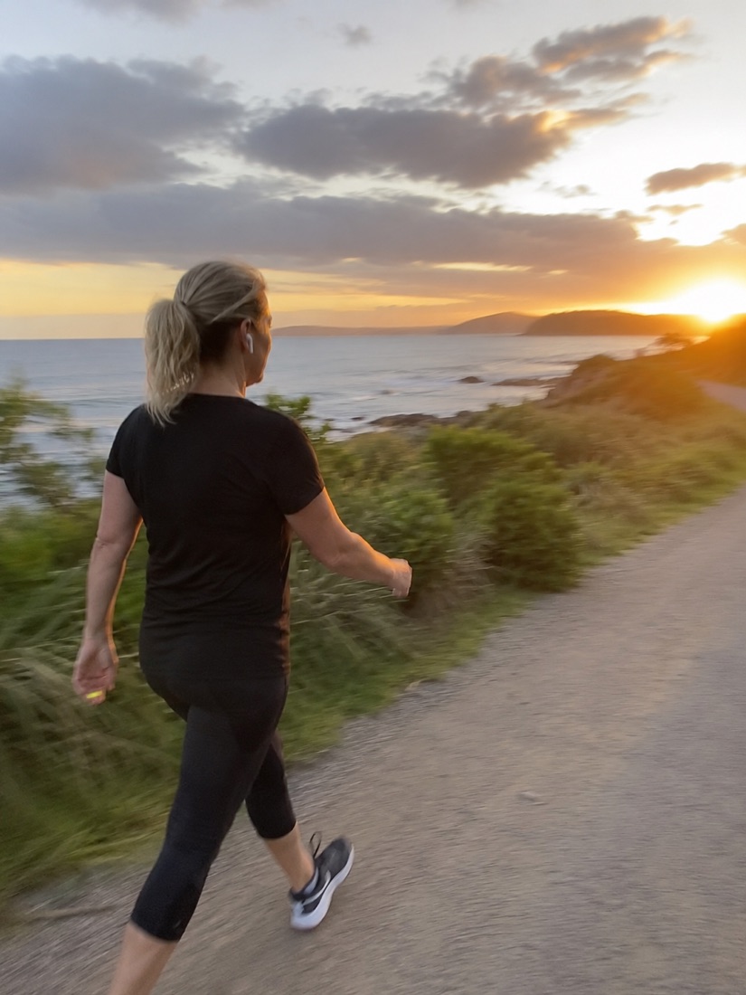 An active person in their fifties walking outdoors with energy