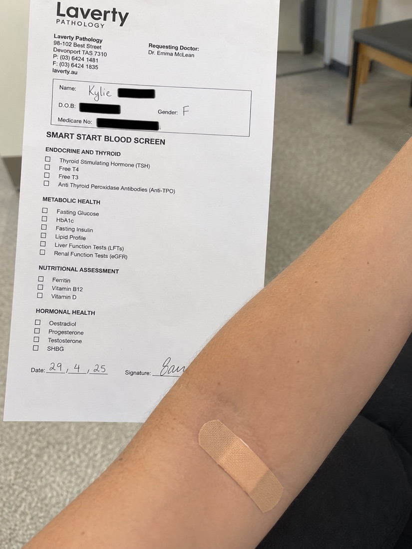 A person reviewing a simple blood test result at a clinic desk
